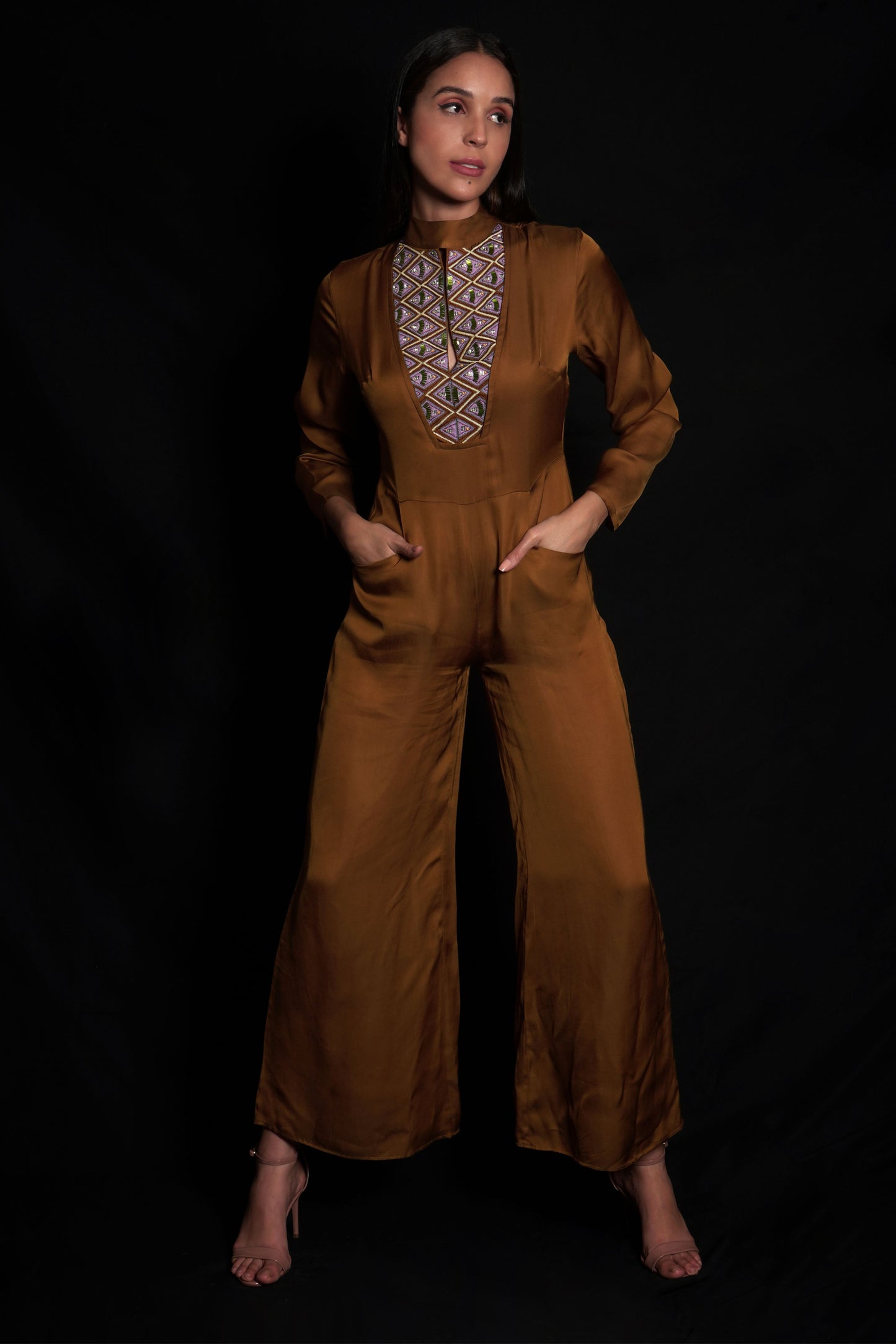Golden brown jumpsuit featuring geometric hand-embroidery