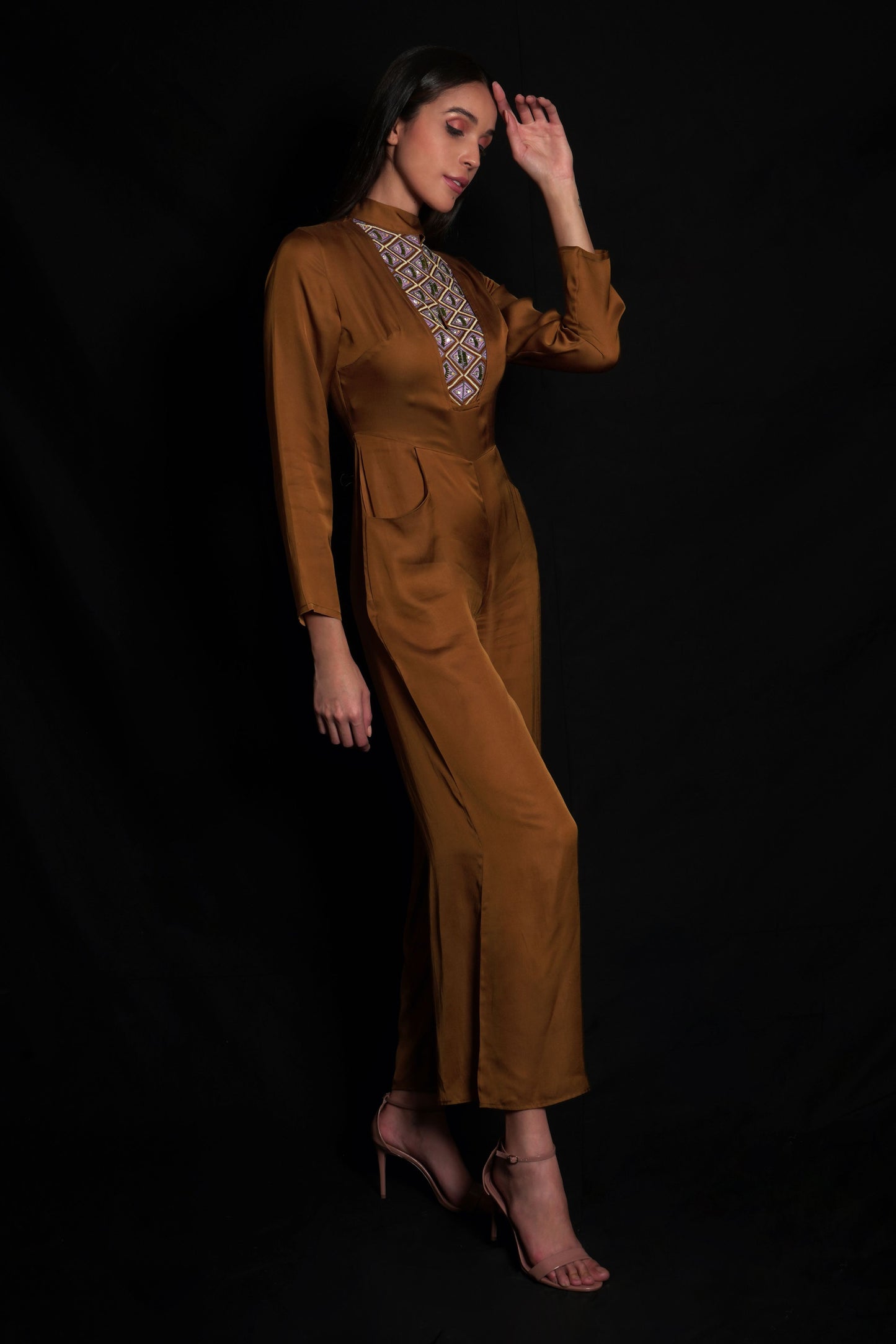 Golden brown jumpsuit featuring geometric hand-embroidery