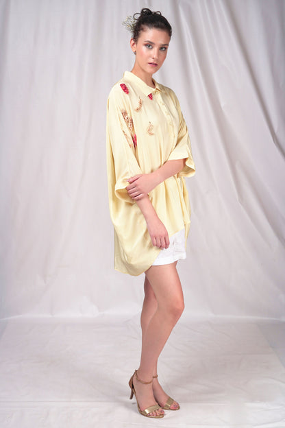 Cream-hued loose fit button-down top with minimal embroidery