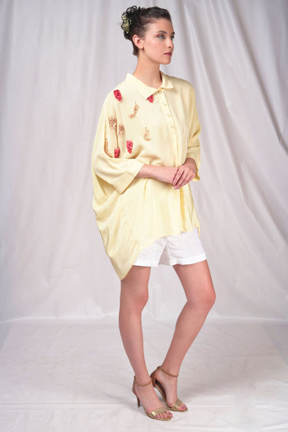 Cream-hued loose fit button-down top with minimal embroidery